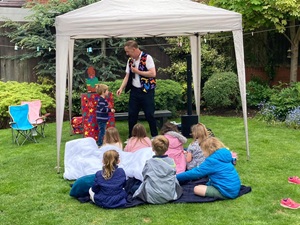 Children laughing as Magic Stuart performs an interactive magic trick