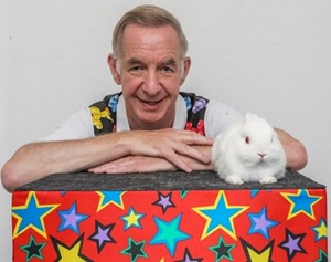 Magician Magic Stuart showing his live rabbit Snowy during a magic act